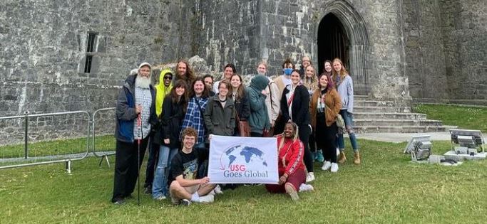 MGA students and faculty posing in front of a castle abroad. 